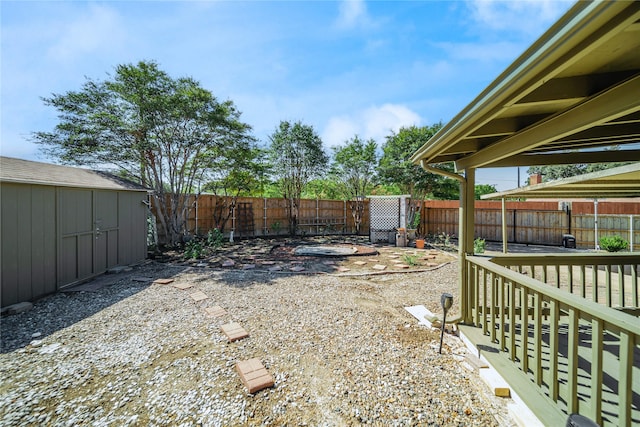 view of yard with a wooden deck and a shed