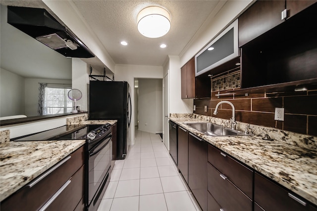 kitchen featuring light tile patterned flooring, dark brown cabinets, black appliances, light stone counters, and sink