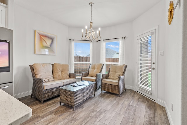 living room with wood-type flooring and a notable chandelier