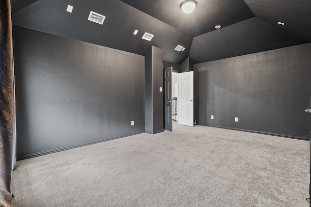 carpeted home theater featuring lofted ceiling