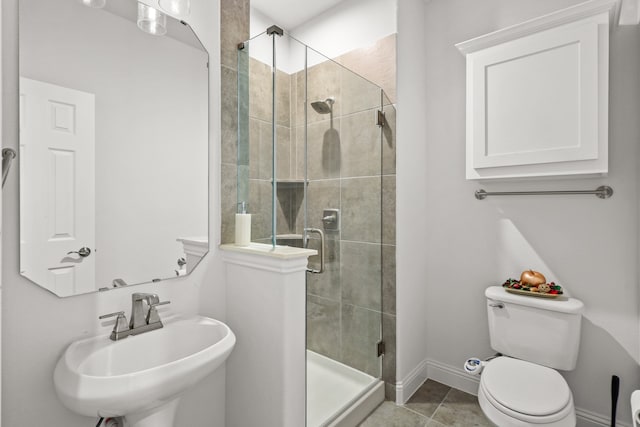 bathroom with walk in shower, sink, toilet, and tile patterned floors