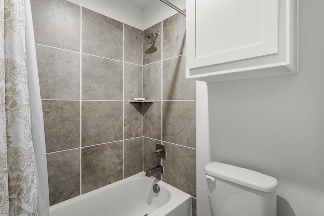 bathroom with shower / bath combo with shower curtain and toilet