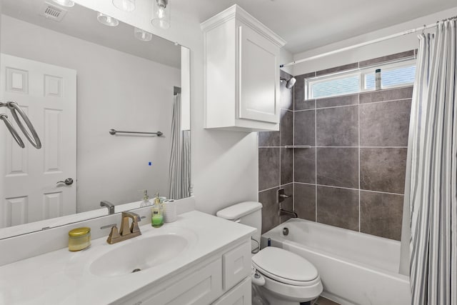 full bathroom with vanity, shower / tub combo, and toilet