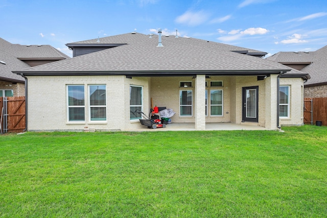 back of house featuring a patio and a yard