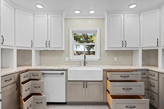 kitchen with gray cabinetry, dishwasher, sink, light stone counters, and white cabinetry