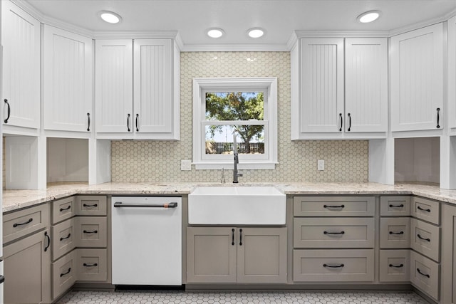 kitchen with dishwasher, light stone counters, gray cabinetry, and sink