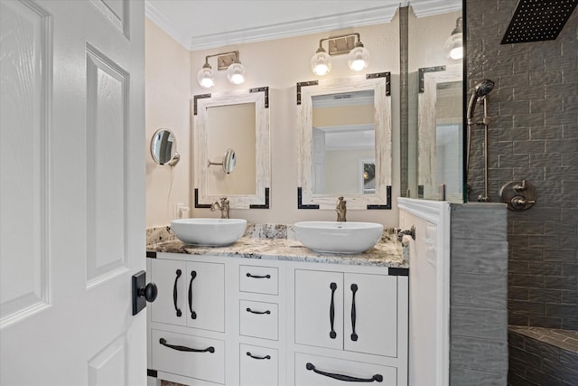 bathroom featuring tiled shower, vanity, and ornamental molding