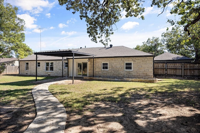 rear view of house featuring a lawn