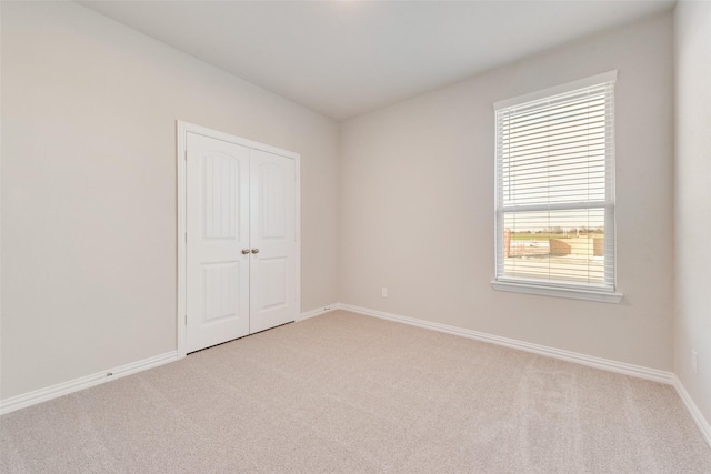 100 Skyward Ln, Caddo Mills, TX 75135 - unfurnished bedroom with light carpet, baseboards, multiple windows, and a closet
