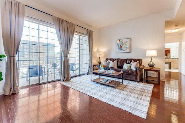 living room featuring hardwood / wood-style flooring and ornamental molding