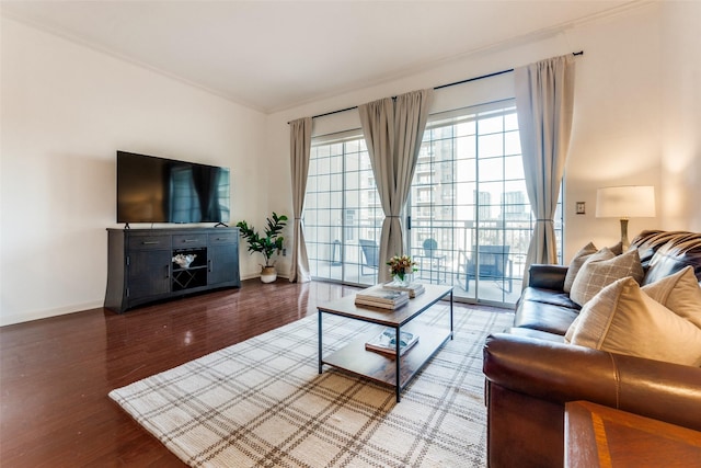 living room with hardwood / wood-style flooring and crown molding