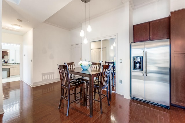 dining room featuring dark hardwood / wood-style floors and crown molding