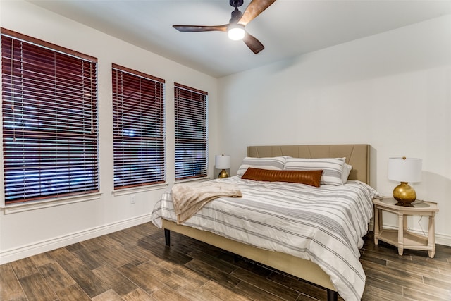 bedroom with ceiling fan and dark hardwood / wood-style floors