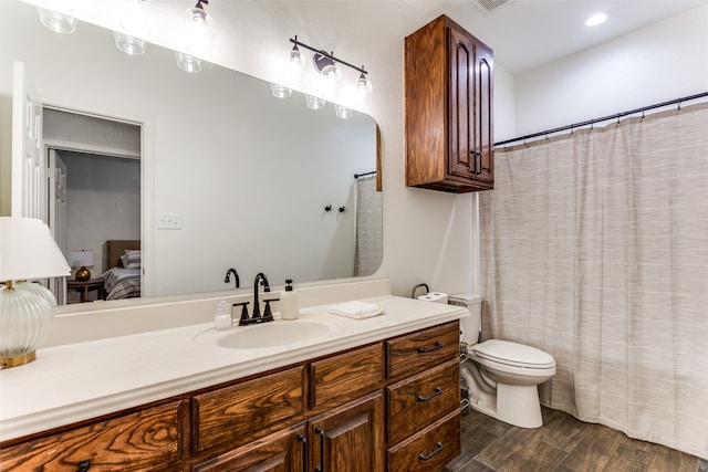 bathroom featuring wood-type flooring, vanity, and toilet