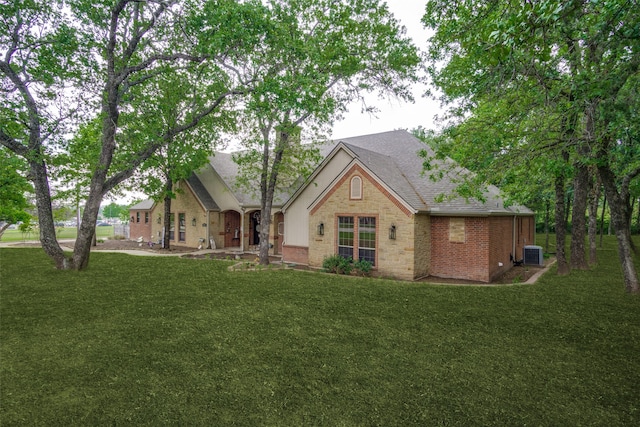 view of front of property featuring a front yard and central air condition unit