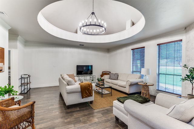 living room with a notable chandelier, a tray ceiling, and dark hardwood / wood-style floors