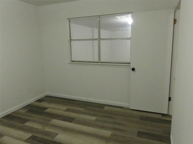 spare room featuring dark hardwood / wood-style floors