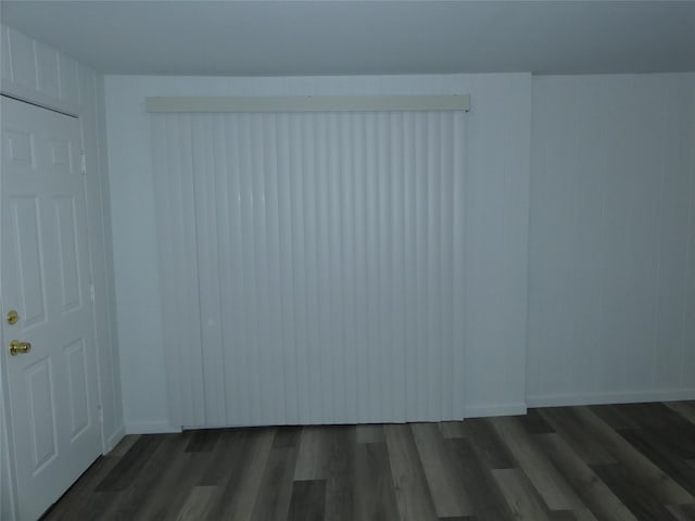 spare room with dark wood-type flooring