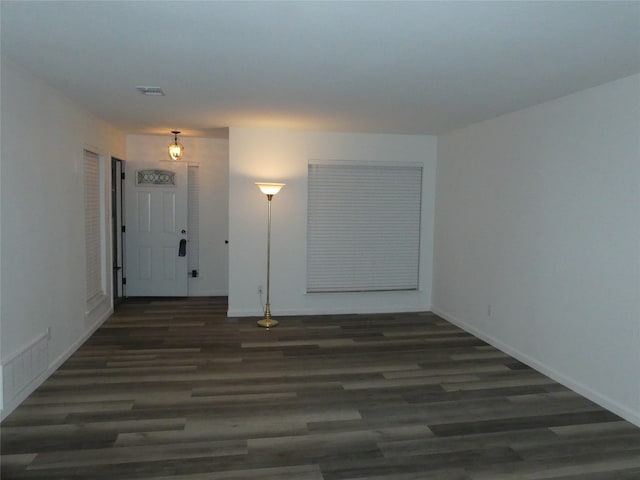 unfurnished room featuring dark wood-type flooring