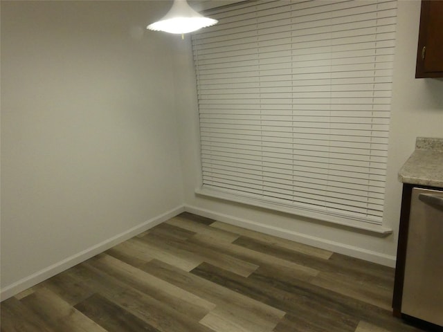 unfurnished dining area featuring dark hardwood / wood-style flooring