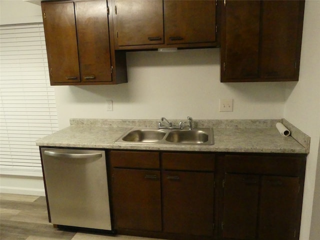 kitchen with dark brown cabinetry, dishwasher, light hardwood / wood-style flooring, and sink