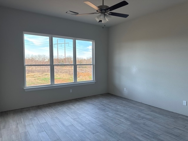 empty room with ceiling fan and light wood-type flooring