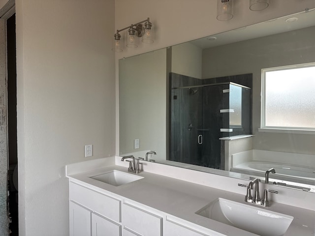 bathroom featuring vanity and independent shower and bath