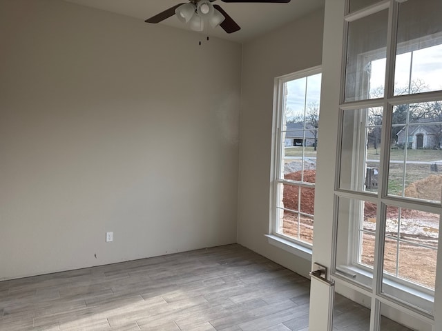 unfurnished room with ceiling fan and light hardwood / wood-style flooring