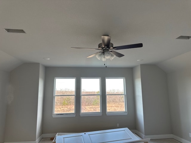 additional living space featuring lofted ceiling, ceiling fan, and a healthy amount of sunlight