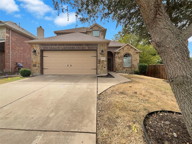 view of front of house featuring a garage and a front lawn