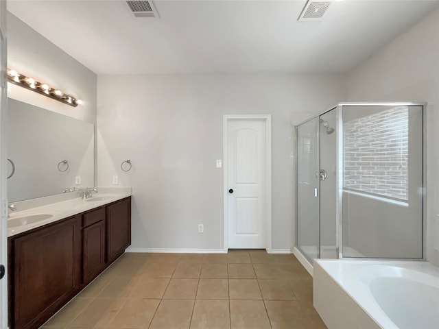 bathroom featuring shower with separate bathtub, vanity, and tile patterned floors