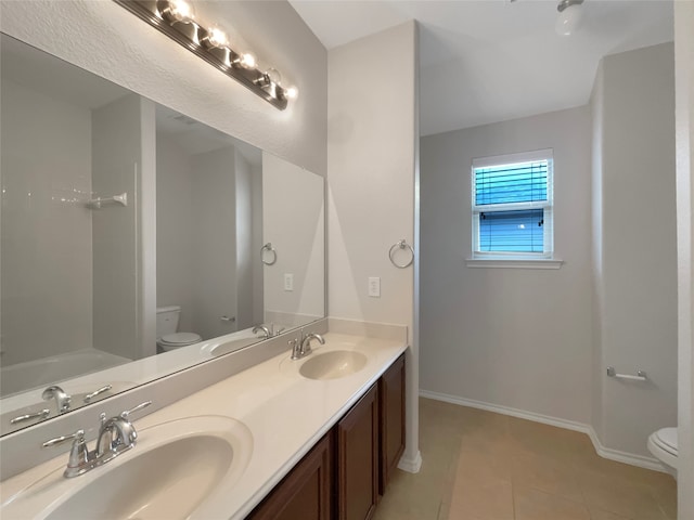 bathroom with a bath, tile patterned flooring, vanity, and toilet