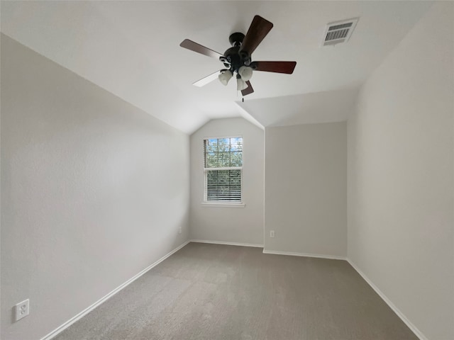 carpeted empty room featuring ceiling fan and lofted ceiling