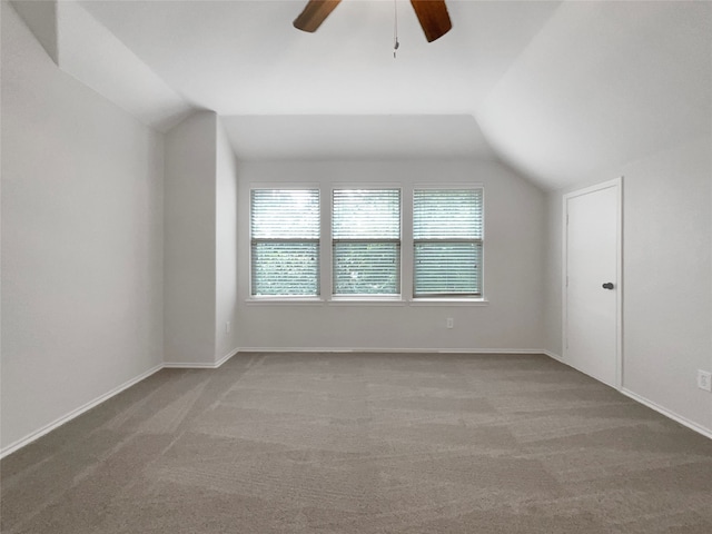 additional living space with ceiling fan, light carpet, and vaulted ceiling