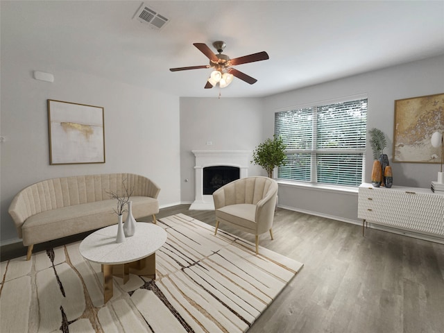 living room featuring ceiling fan and hardwood / wood-style flooring