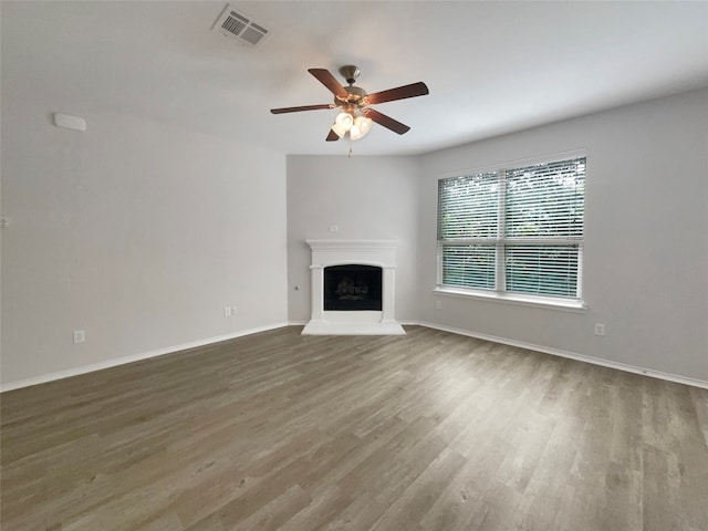 unfurnished living room featuring ceiling fan and hardwood / wood-style flooring