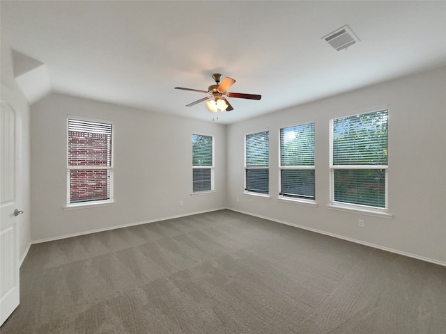 spare room with a wealth of natural light, vaulted ceiling, and ceiling fan