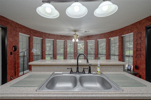 1498 Riley Rd, Whitesboro, TX 76273 - kitchen with a sink, a ceiling fan, light countertops, and a textured ceiling