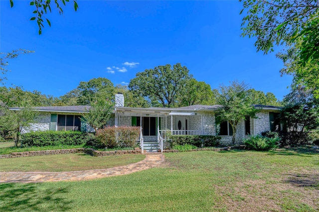 1498 Riley Rd, Whitesboro, TX 76273 - single story home featuring stone siding, a front yard, a chimney, and covered porch