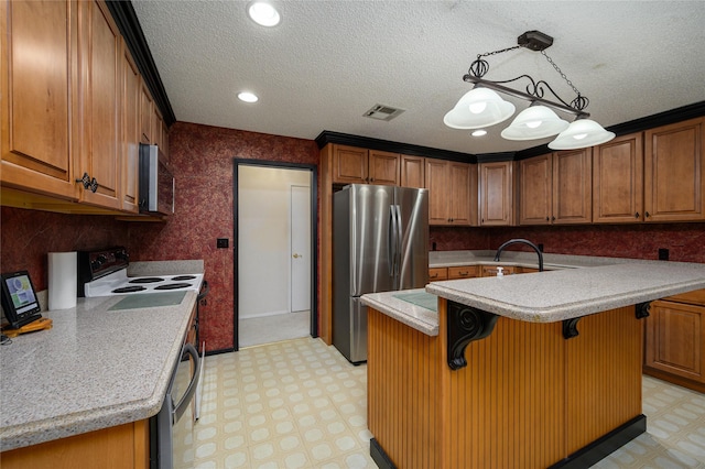 1498 Riley Rd, Whitesboro, TX 76273 - kitchen with appliances with stainless steel finishes, light flooring, light countertops, a breakfast bar, and an island with sink