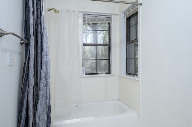 bathroom featuring shower / bathtub combination with curtain