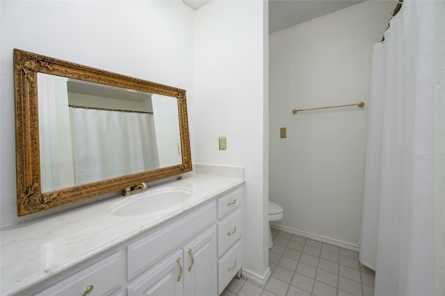 bathroom featuring a textured ceiling, vanity, toilet, and tile patterned floors