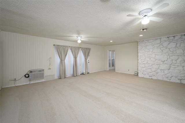 carpeted empty room featuring a textured ceiling, ceiling fan, and a wall mounted AC