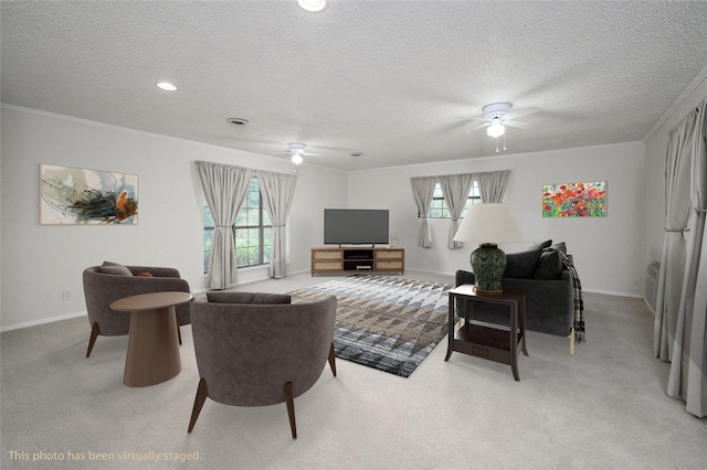 1498 Riley Rd, Whitesboro, TX 76273 - living area featuring ceiling fan, plenty of natural light, crown molding, light colored carpet, and a textured ceiling