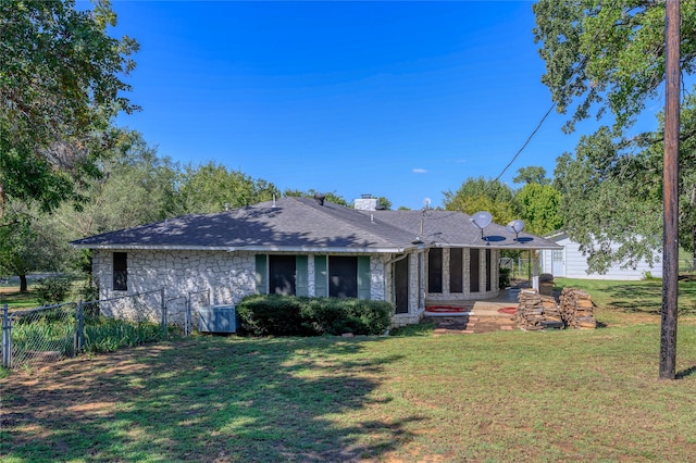 back of property featuring a yard