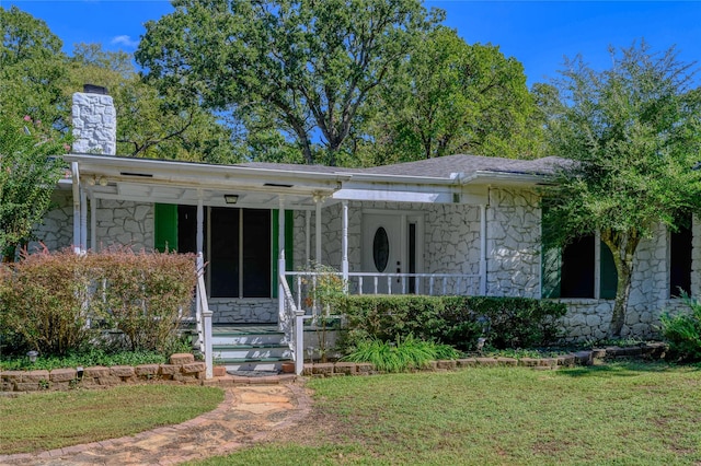 1498 Riley Rd, Whitesboro, TX 76273 - bungalow-style home featuring stone siding, covered porch, a chimney, and a front lawn