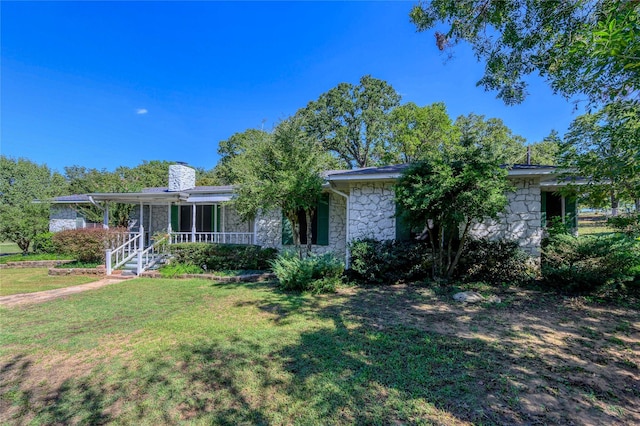 1498 Riley Rd, Whitesboro, TX 76273 - view of front facade with stone siding, a porch, a front yard, and a chimney