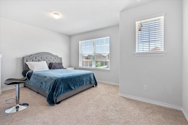 bedroom featuring light carpet