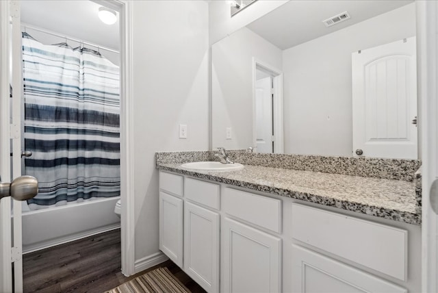 full bathroom with vanity, hardwood / wood-style floors, toilet, and shower / bathtub combination with curtain