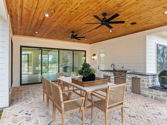 view of patio with an outdoor kitchen, area for grilling, and sink